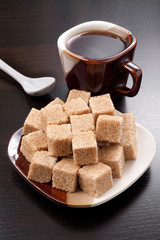 Brown sugar cubes and coffee cup