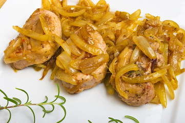 Pork sirloin steaks under onion