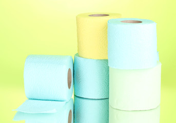 bright rolls of toilet paper on green background