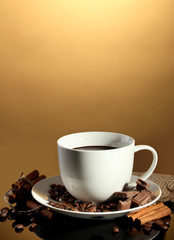 cup of coffee and beans, cinnamon sticks and chocolate