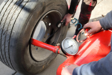 Mechanic working on a tire with bead seater