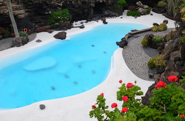 Blue swimming pool in tropical garden