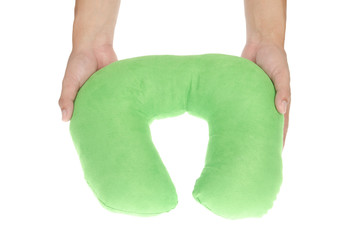 Hand holding inflatable travel cervical pillow isolated on a whi