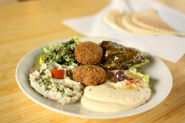 Falafel plate with hummus, baba ganoush, tabouli, and dolmas.