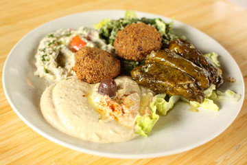 Falafel plate with hummus, baba ganoush, tabouli, and dolmas.