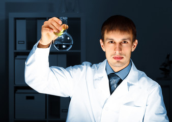 Young chemist working in laboratory