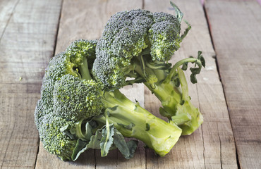 two broccoli on wooden background