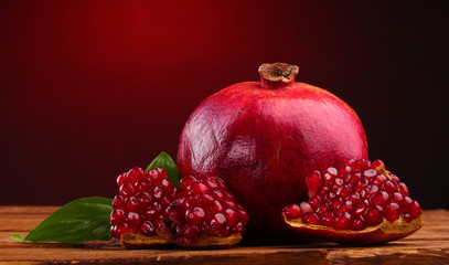 Obraz na płótnie Canvas ripe pomegranate fruit with leaves