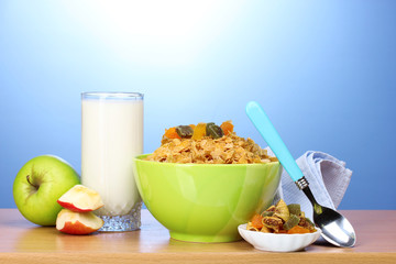 tasty cornflakes in green bowl, apples and glass of milk
