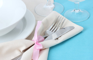 Table setting with fork, knife, plates, and napkin