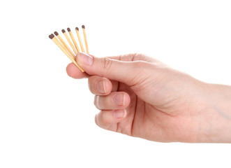 Matches in hand isolated on white