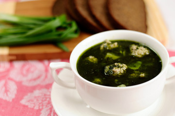 Soup with spinach and meatballs