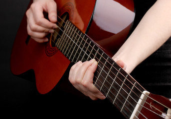 Fototapeta na wymiar Guitar in hands isolated on black