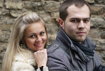 Young Woman Smiling From Behind Her Boyfriend