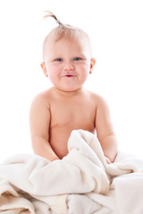 adorable baby playing with white blanket