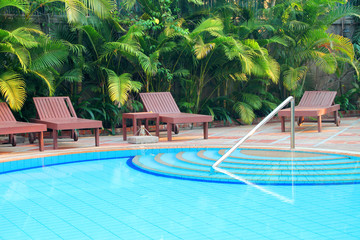 Wooden pool trestle beds by the poolside