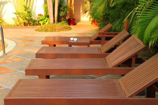 Wooden pool trestle beds by the poolside