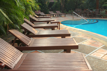 Wooden pool trestle beds by the poolside