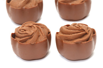 Chocolate pralines on white background