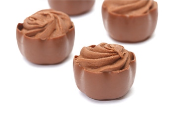 Chocolate pralines on white background