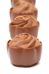 Chocolate pralines on white background