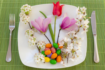 Easter place setting with spring flowers and blossom