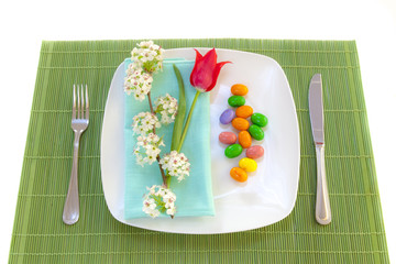 Easter place setting with spring flowers and blossom