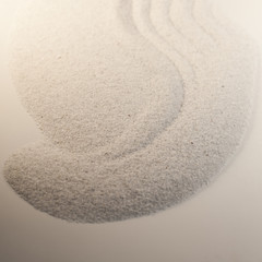 dessin design dans le sable fin blanc