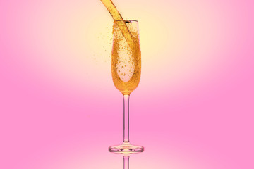 Champagne in a glass on pink background