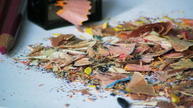 Colored pencils, sharpener and pencil shavings rotating