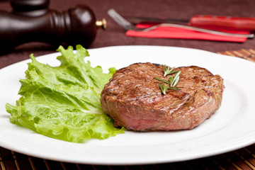 Grilled steak on a white plate