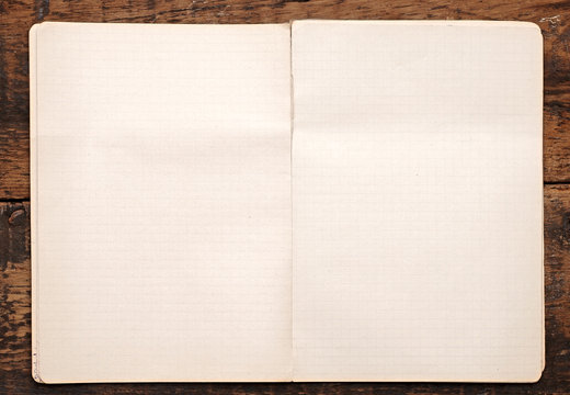 White Paper Pulled Out From A Notebook On A Wood Background