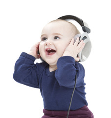 young child with ear-phones listening to music