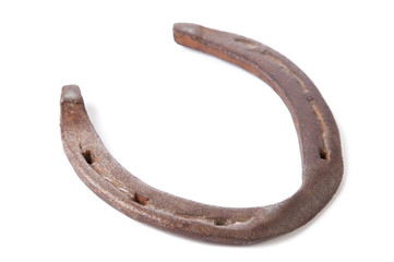 Close-up of an old, rusty horseshoe, isolated on white