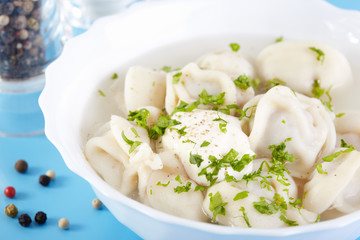 Traditional Russian cuisine. Pelmeni with broth