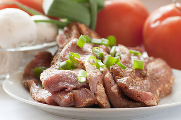 Fresh raw pork with fresh, vegetables.