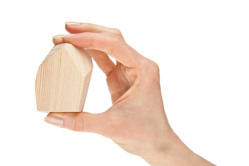 Human hand holding wooden block