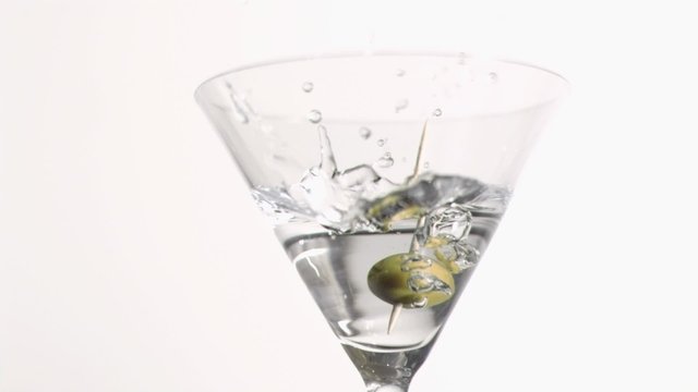 Green olive falling in super slow motion
