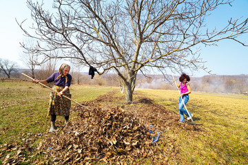 Mother and daughter working in an orchard