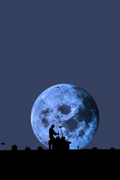 chimney sweep silhouette on the rooftop against full moon