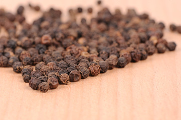 Black pepper on the wooden cutting board