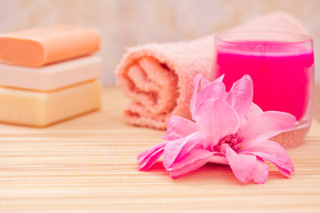 daily spa objects, towel, soaps, candle, flower