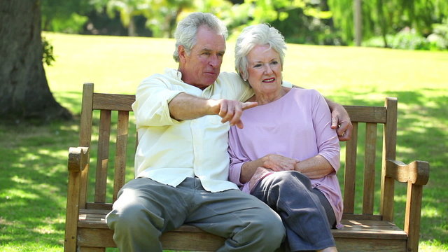Mature man showing something to his wife