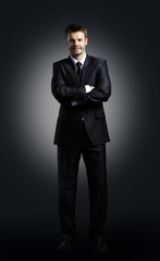 Obraz na płótnie Canvas Fashion trendy elegant young black suit man posing