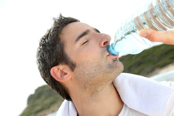 Jogger drinking water after exercising