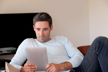 Man websurfing on internet with digital tablet