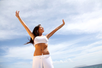 Woman stretching arms towards the sky