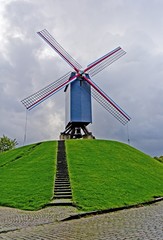 Old Windmill in old Brugge City in Belgium against Cloudy Sky