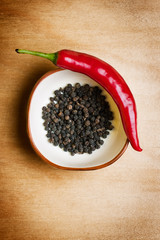 red hot chili black pepper on wood table