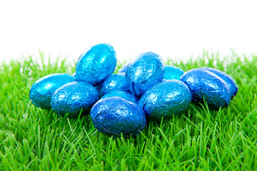 Blue chocolate easter eggs on grass